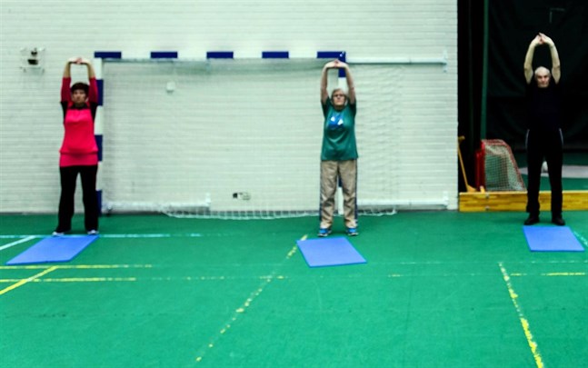 Motionärer stretchar i Sportishallen i Bennäs.