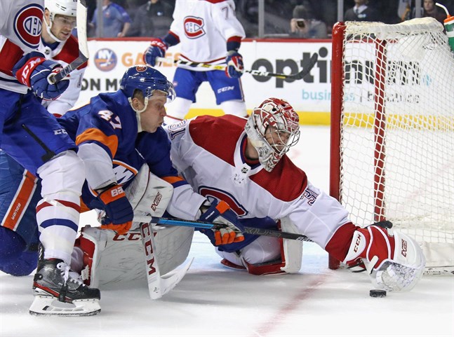 Carey Price i Montreal Canadiens hinner på pucken före Leo Komarov i New York Islanders när lagen möttes den 3 mars.