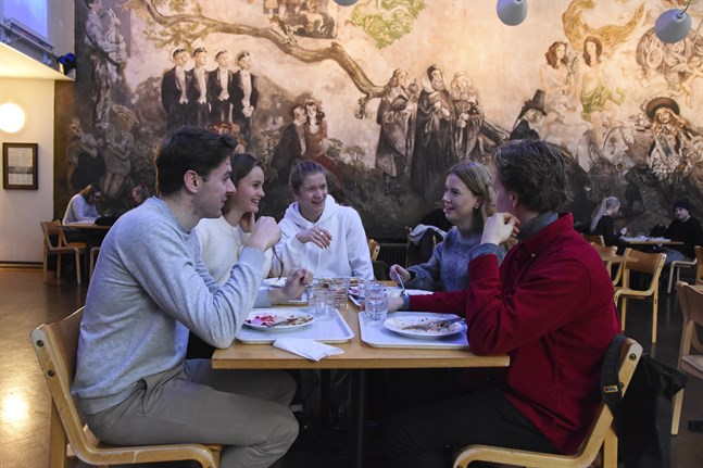 (Fr.v.) Thomas Sjöberg, Lotta Arola, Linus Höglund, Maja Meurman och Pietari Matilainen, alla första årets studenterande i samhällsvetenskaper, äter lunch på Kåren. Eftersom restauranglokalen ännu renoveras har festsalen förvandlats till lunchrestaurang. – Vi talade just om att de har ordnat det jättefint här, säger Arola.