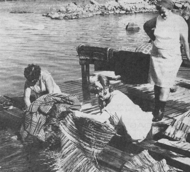 Siv Nygård från Valsberg och Julia Hertsbacka från Rangsby tvättar sina mattor vid bryggan i Fagerö. Julia Lind från Valsberg väntar på sin tur.